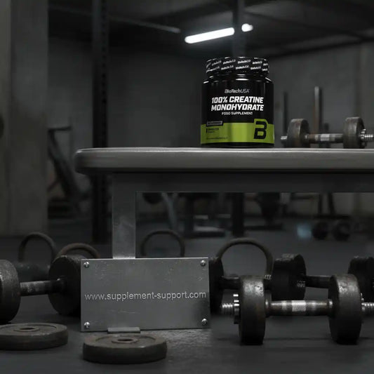 BioTechUSA 100% Creatin Monohydrat Supplement auf einer Hantelbank im Fitnessstudio.